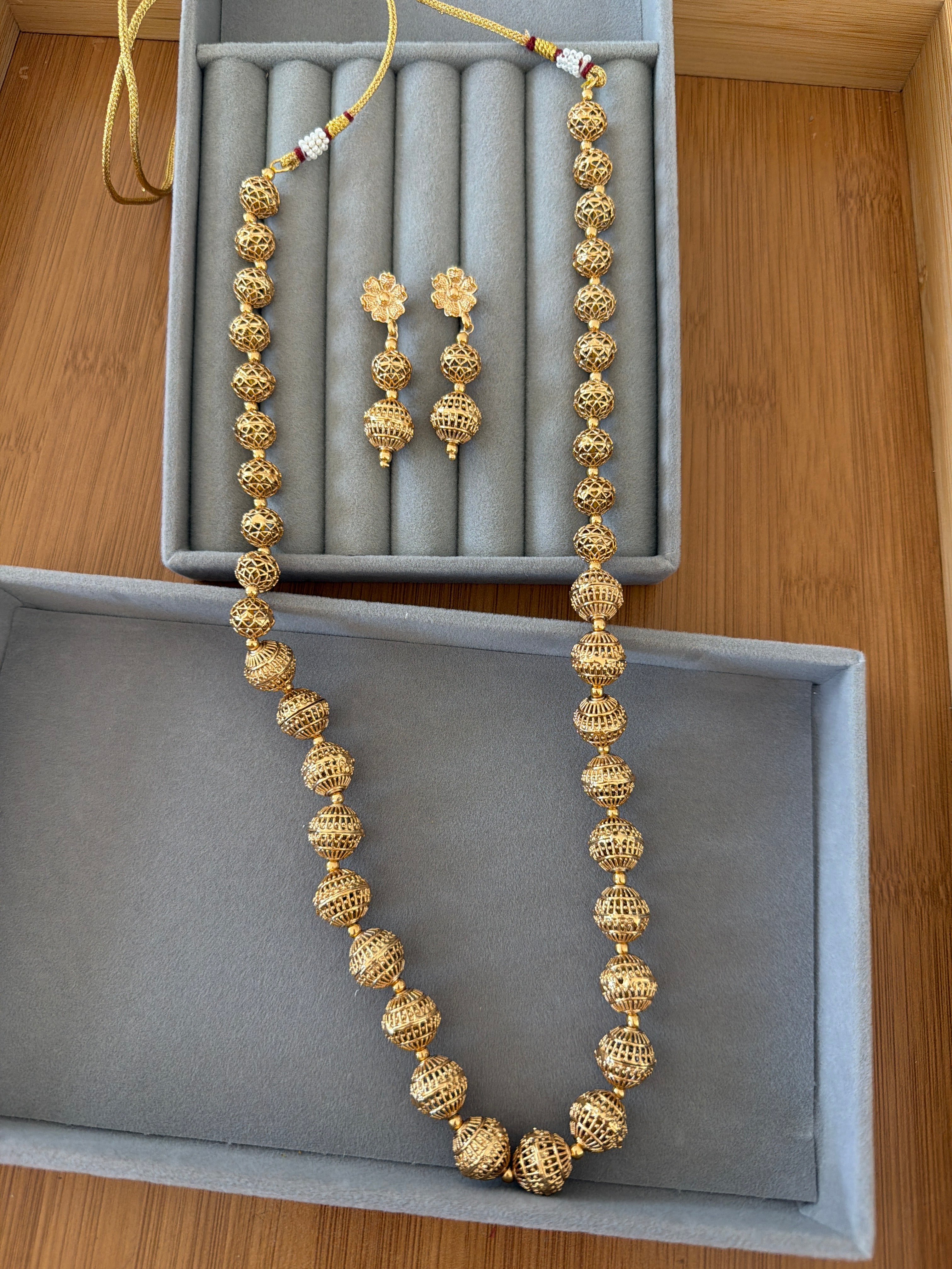 Long golden bead necklace